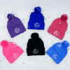Adult knit beanie hat w/ cuff and pom featuring our Circle of 3E Love embroidered with white threads. Assorted colors including: heather purple, royal blue, heather red, pink, black, and heather blue.