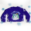 2021's limited edition long-sleeve t-shirt holiday design features a jolly snowman sporting a 3E Love knit scarf and holding a warm mug of hot cocoa 