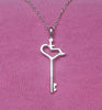 Our International Symbol of Acceptance Wheelchair Heart sits atop an antique style key. 